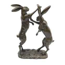 A bronze figure group, modelled as two male hares boxing, upon a naturalistic base, with foundry mark, H27cm.
