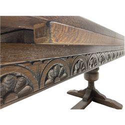 20th century oak drawer leaf extending dining table, two foliage carved baluster supports on sledge feet joined by floor stretcher 
