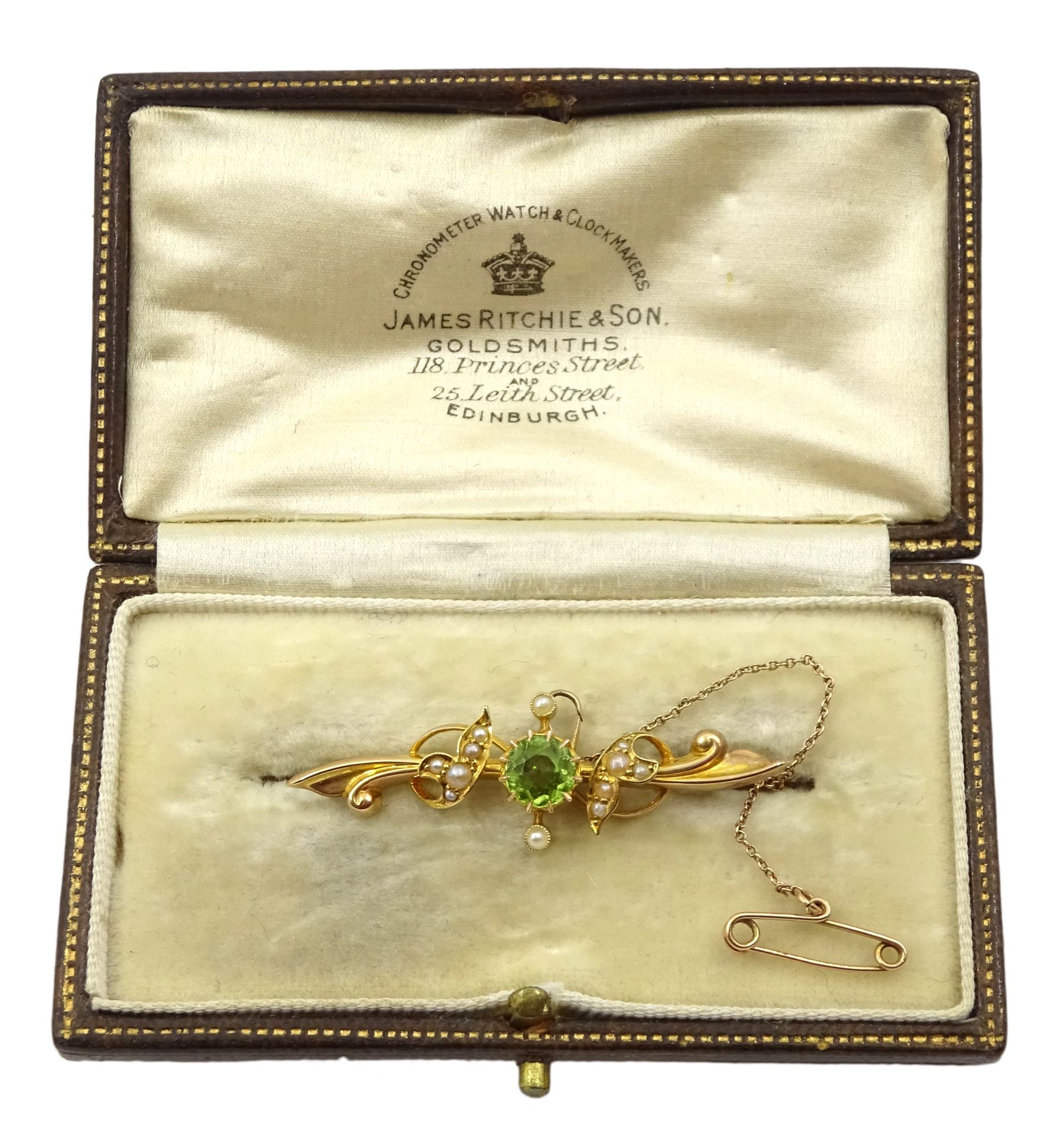 Edwardian gold peridot and split seed pearl bar brooch stamped 15ct, boxed
