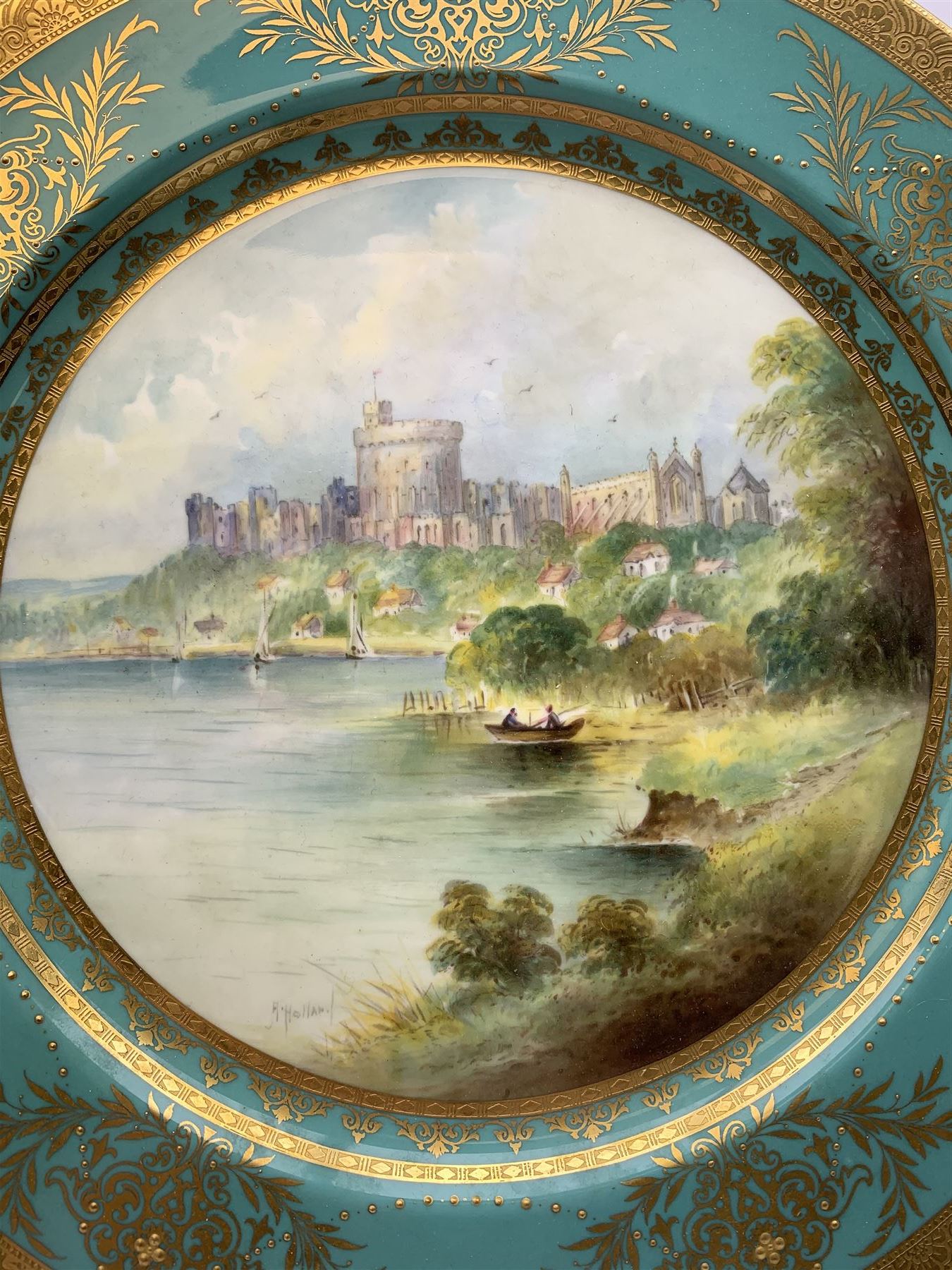 Large Minton cabinet plate, with central hand painted panel of Windsor Castle, signed A Holland, within a tooled gilt turquoise border, with impressed and printed marks and inscribed Windsor Castle beneath, D32cm