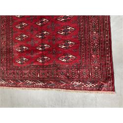 Turkman Bokhara rug, red ground field decorated with repeating Gul motifs