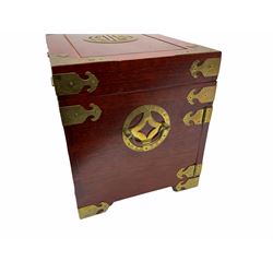 Chinese hardwood jewellery box mounted with engraved brass fixtures, the two exterior doors revealing three drawers below the hinged upper lid, lined with red material decorated with floral sprays, H25cm, W36cm, D23cm
