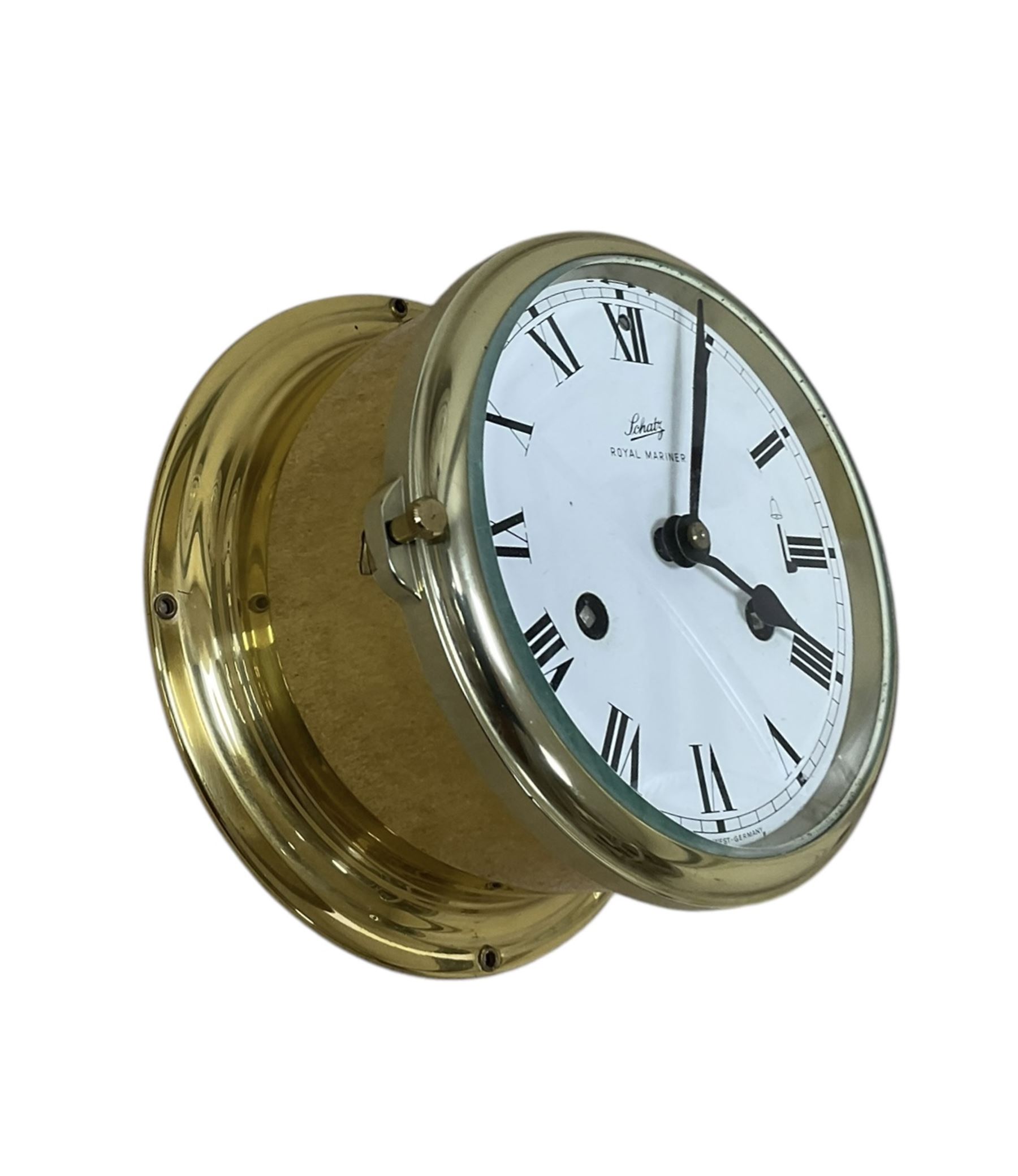 Schatz- 20th century Royal Mariner brass cased bulkhead mounted ships clock, twin train spring driven 8-day movement sounding the nautical watches on a bell, with a 5” dial, Roman numerals and spade hands. With key.  