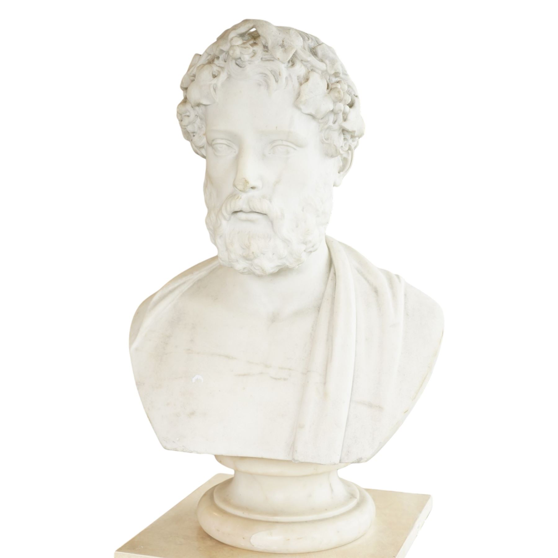 Aristide Louis Fontana (Italian 1834-1907): Grand Tour marble bust of a Roman emperor, probably inspired by portraits of Marcus Aurelius, portrayed with finely carved curled hair and beard beneath a grapevine wreath with trailing vine leaves and clusters of fruit, the draped shoulders and truncated chest raised upon a turned circular socle, signed to the reverse, H61cm; together with the associated faux marble pedestal of rectangular form, H94cm
Provenance: Kirkham Hall