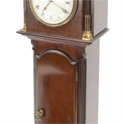 Early 20th century - mahogany cased 8-day miniature longcase clock with a matching wall mounted bracket,  break arch hood with ball finials and recessed quarter pilasters, conforming trunk with a long door and break arch top on a decorative plinth with a raised panel and stepped base, circular dial with Roman numerals and spade hands within a glazed bezel, French insert timepiece movement with a cylinder platform escapement, wound and set from the rear. With key.
