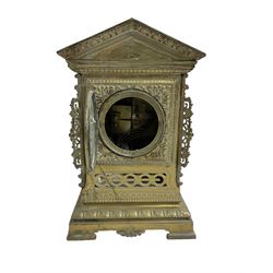 French- early 20th century 8-day  brass cased eight-day mantel clock and pair of pierced brass vases, clock case with an architectural pediment and pierced scrollwork on a recessed plinth raised on bracket feet, two part dial with a decorative centre and enamel chapter, Arabic numerals and spade hands, rack striking movement striking the hours and half hours on a coiled gong. With pendulum.
