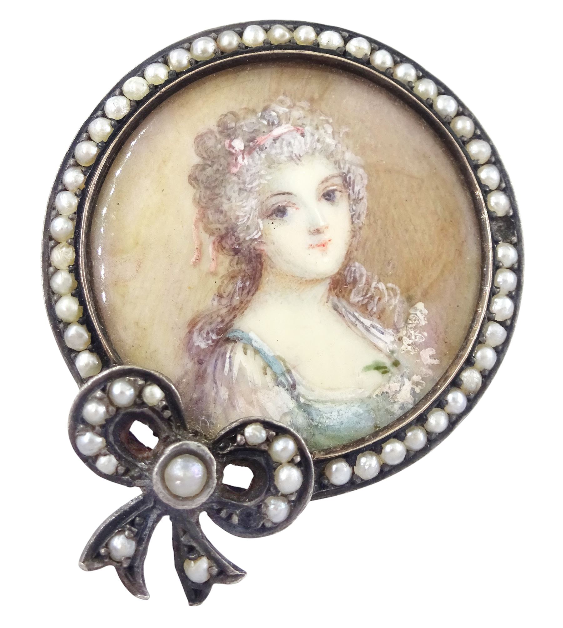 Three 19th century silver portrait brooches, each set with miniatures of women in 18th century dress on ivory, two with seed pearl surrounds and the other within a foliate paste set surround. This lot has been registered for sale under Section 10 of the APHA Ivory Act