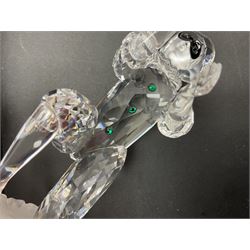 Swarovski Crystal Masquerade trilogy; 1999 Masquerade Pierrot, 2000 Columbine, 2001 Harlequin all with accompanying plaque, stand and original box, together with a glass display case with mirrored back and sides 