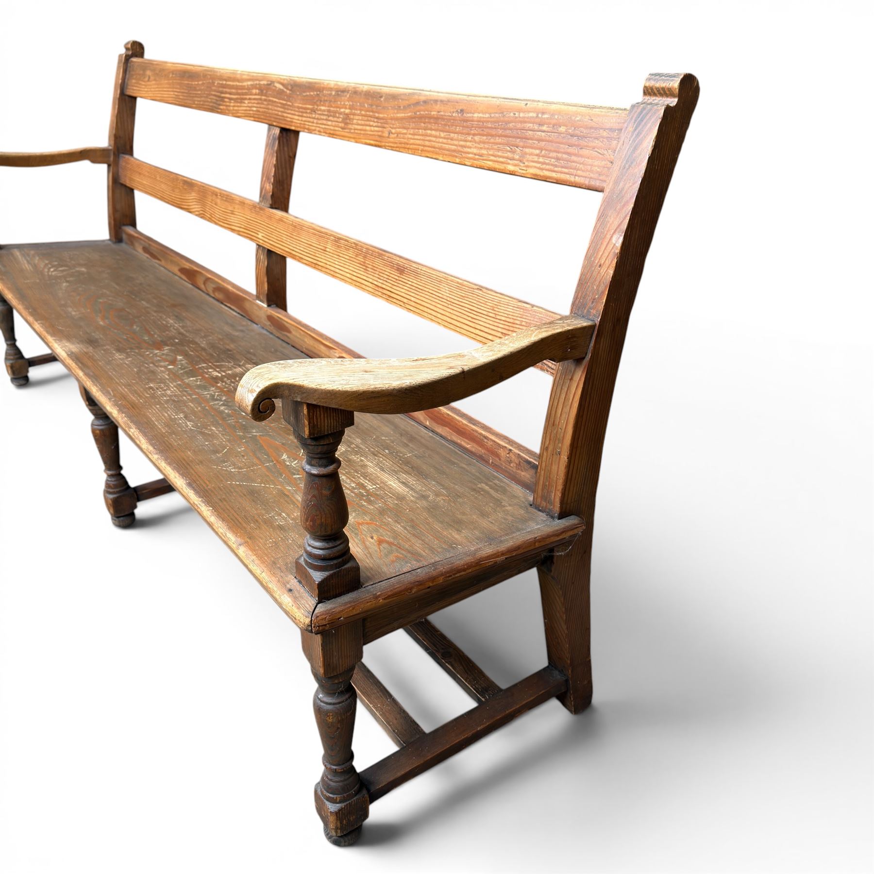Early 20th century pine and oak bench seat, stained pine rail back frame with shaped oak arms