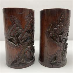 Pair of Chinese carved bamboo brush pots, decorated with figures in a pagoda landscape, H19cm