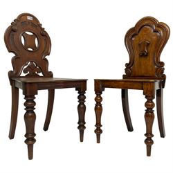 19th century mahogany hall chair, pierced and carved shaped back decorated with C-scrolls, solid seat raised on turned supports (W46cm H88cm); together with another similar (W41cm H87cm)