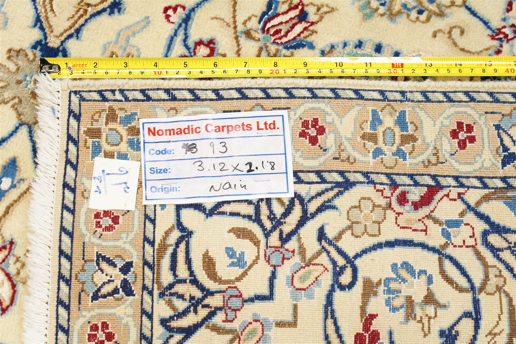 Central Persian Nain hand-knotted carpet, ivory field with central finely drawn cusped medallion of radiating palmette and arabesque form with scrolling vine work, flowering tendrils and stylized foliate motifs in a palette of pale blue, indigo, crimson and sage accents, spandrels of conforming design enclosing intricate floral sprays and arabesques within  multiple borders and narrow guard stripes, with cotton fringe ends 