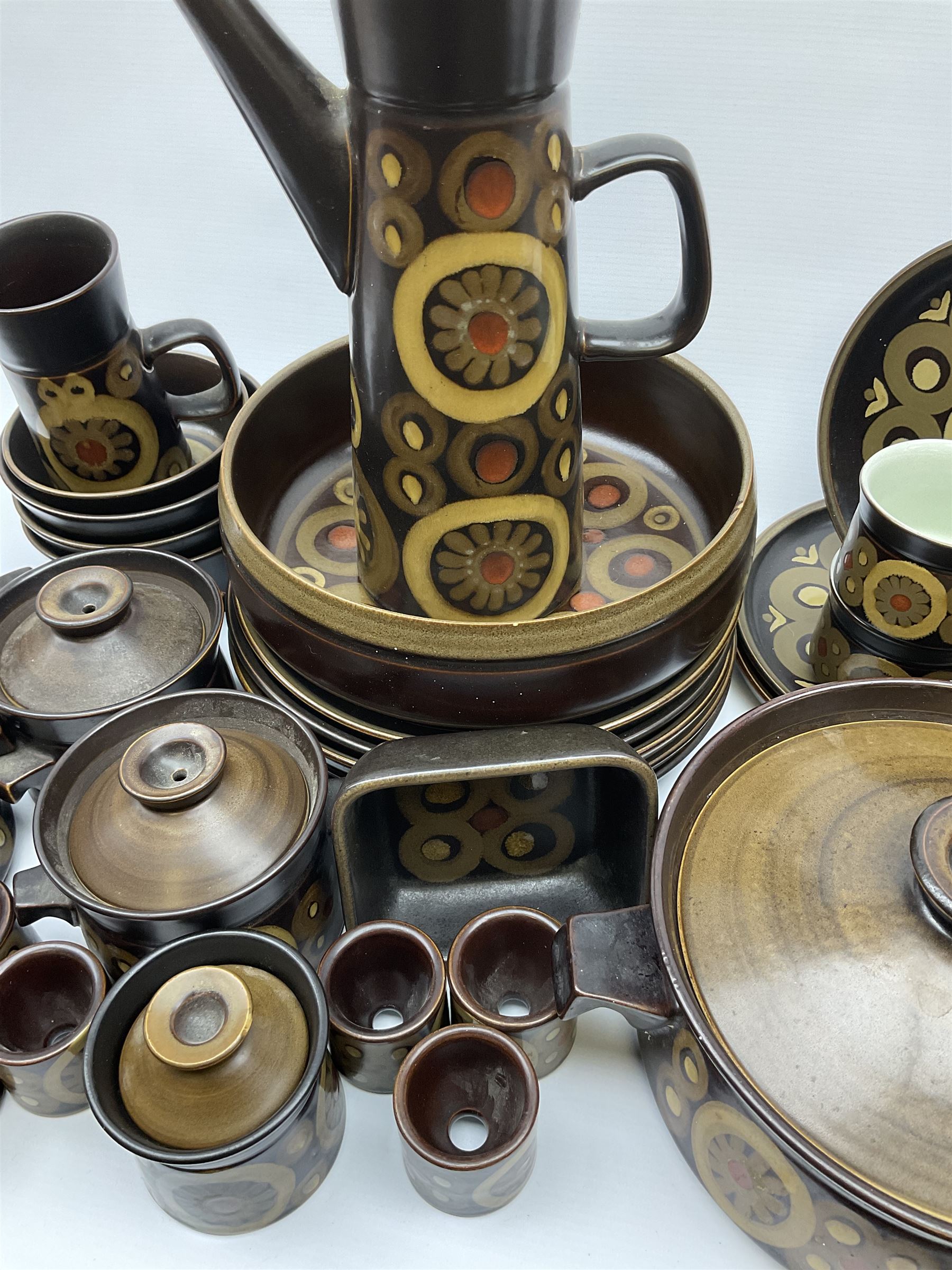 Denby Arabesque pattern tea and dinner wares, comprising large serving bowl,  five dinner plates, three side plates, four twin handled bowls and covers, one bowl and cover, four bowls, salt and pepper shaker, pan with lid, six egg cups, small serving dish, coffee pot, water jug, milk jug, jug with handle,  two sucriers and covers, four tea cups and one coffee