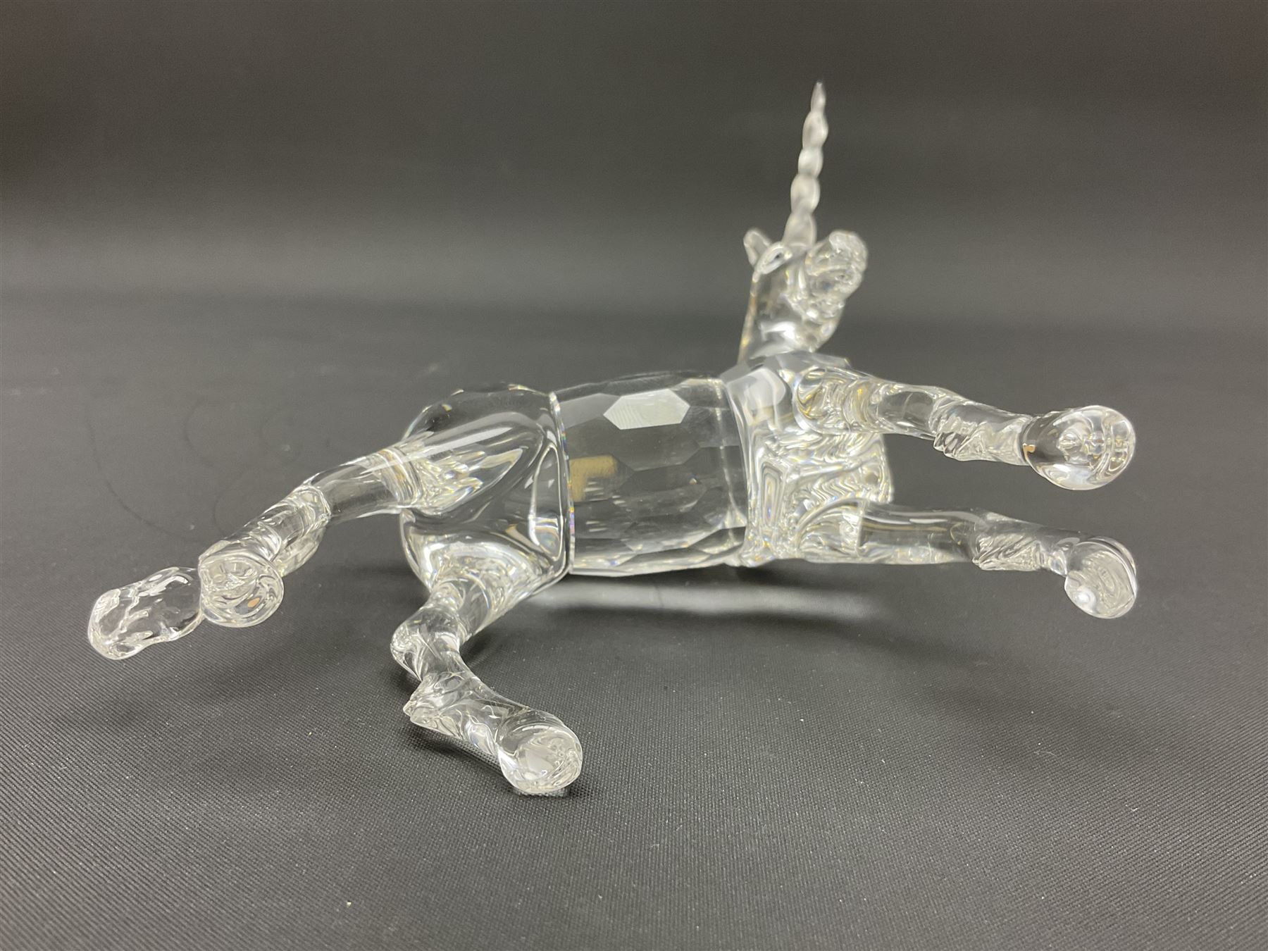 Swarovski Crystal animals, comprising white peacock, the tail with cascading blue flowers, perched eagle with yellow beak, ibex with frosted crystal horns and unicorn with frosted crystal horn, tallest H13cm