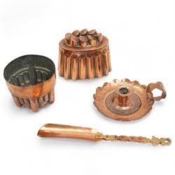 Two copper jelly moulds, together with an arts and crafts style copper chamberstick and sh...