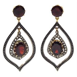 Pair of teardrop shaped oval and round garnet and diamond set pendant earrings