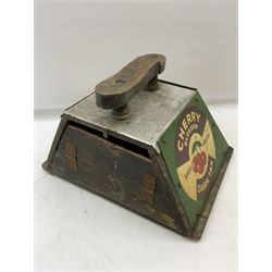Cherry Blossom Shoe Polish shoe shine box, of sloping form, with three pictorial enamel panels advertising dark tan, black and light tan polishes, the reverse with a hinged compartment, the top mounted with a handle and foot rest in the form of a shoe sole, H29cm W42cm D33cm