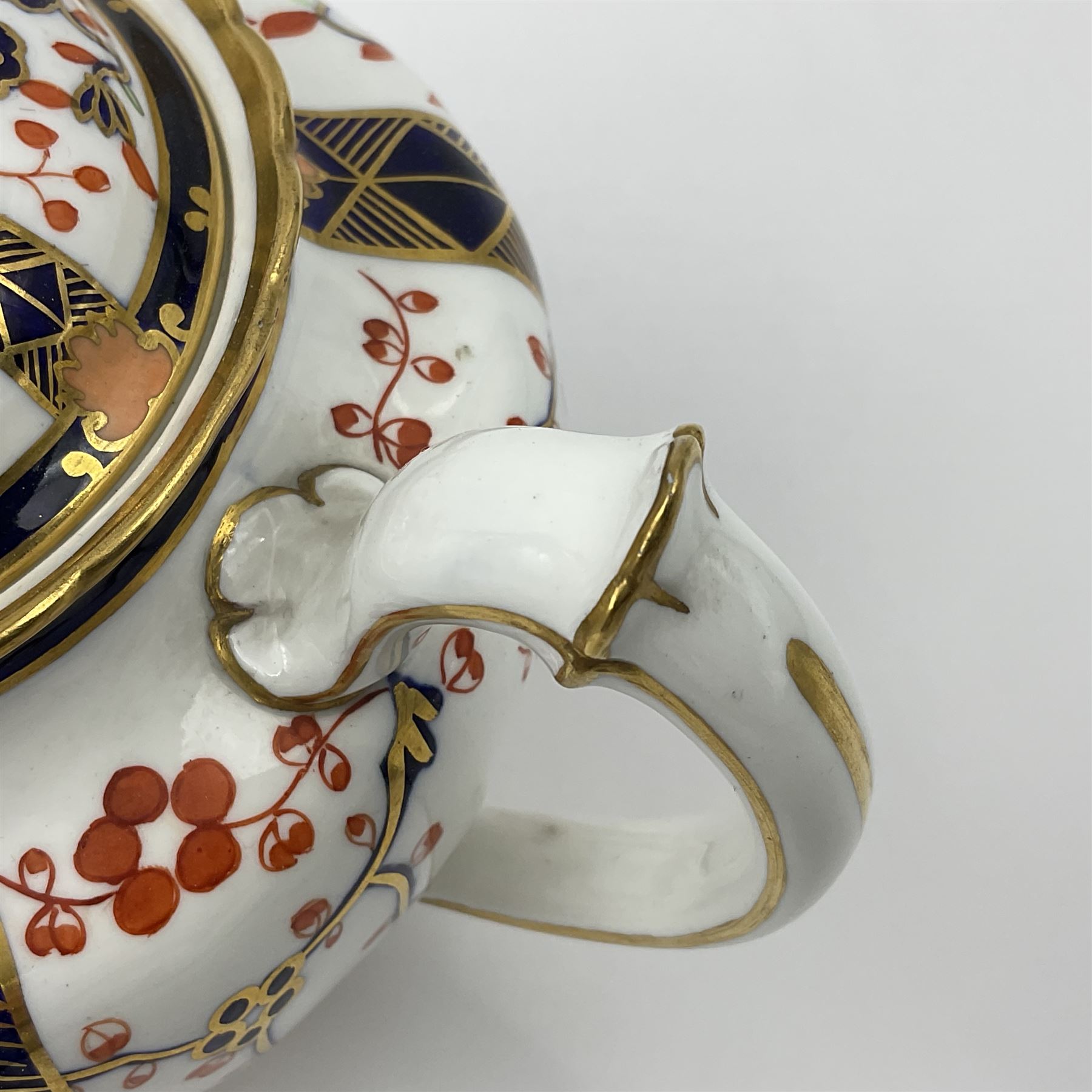 Early 20th century Royal Crown Derby teapot, decorated in a variant of the Imari pattern with blue and red prunus blossoms, with printed mark beneath including illustration date code for 1927, H14cm
