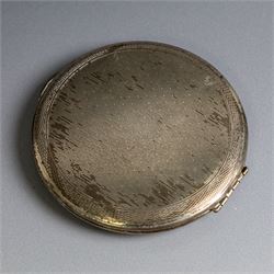 Two silver compact mirrors, comprising a Kigu powder compact with engine turned decoration and a compact mirror with floral decoration, both hallmarked