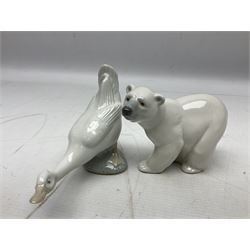 Seven Lladro figures, comprising Playful Puppy no 9135, Platero and Marcelino/Boy Hugging Donkey no 1181, Mini Seal Family no 5318, Attentive Polar Bear no 1207, Seated Polar Bear no1209, Eskimo Boy with Pet no 5238 and Girl with Geese no 1035, together with Nao goose