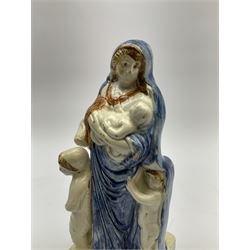 Late 18th century Prattware figure representing Charity, modelled as a mother with baby in her arms and two small children clutching at her robes, upon a square base, overall H21cm.