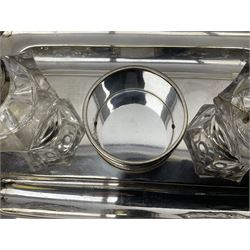 Silver plated desk stand and chamberstick, with two glass inkwells, each with hallmarked silver collars and five silver plated napkin rings
