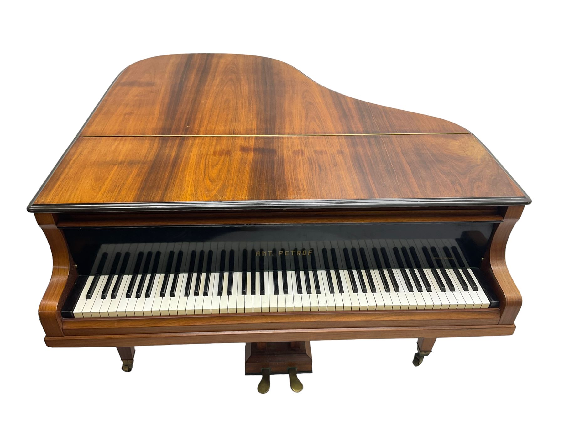  Antonin Petrof - Walnut overstrung baby grand piano, 7 0catve 85 key compass with original strings, tuning pins, damper felts and hammer heads, with roller keyboard action and iron frame, sustaining and una-corda pedals, sliding open lattice music desk, supported on square tapering legs with brass cups and castors, with inner ebonised key fall and ivorine label inscribed 'Supplied by Harrods, London'.