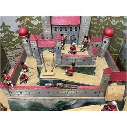Compositional wooden toy castle, enclosed within a box with chromolithographic printed paper of a forest, with painted metal soldiers; box H34cm, W50cm  