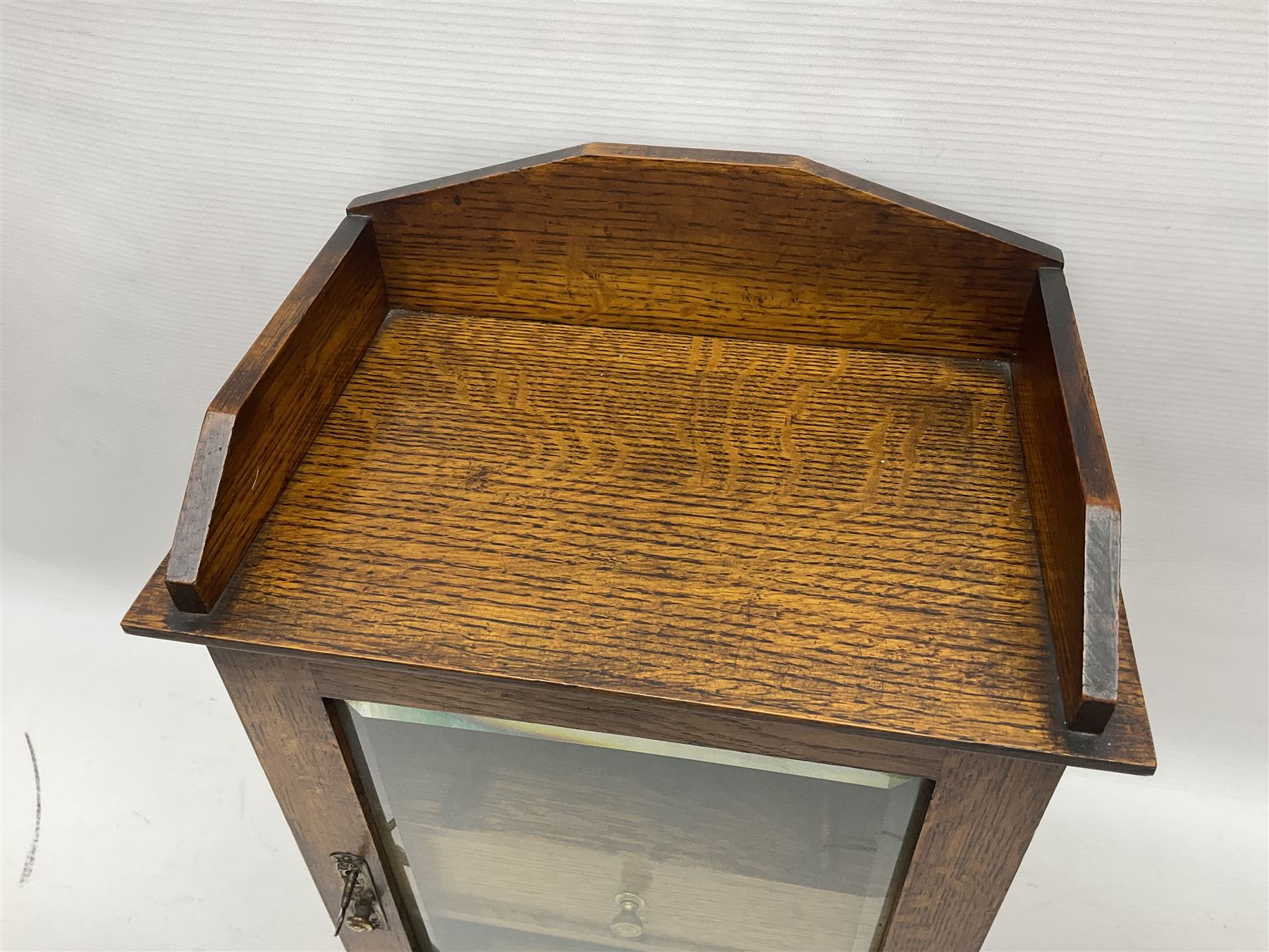 Edwardian oak smokers cabinet with the single glazed door to fitted interior having a single draw and pipe rack, H40cm
