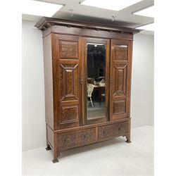 Large late Victorian walnut wardrobe, projecting cornice of central bevelled mirror and two panelled doors, two drawers to base