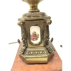  Pair French gilt metal and ceramic table lamps, each of two-handled urn form with ceramic printed panels depicting romantic scenes, raised on red veined marble plinths with scroll feet and frosted glass shades, H72cm   