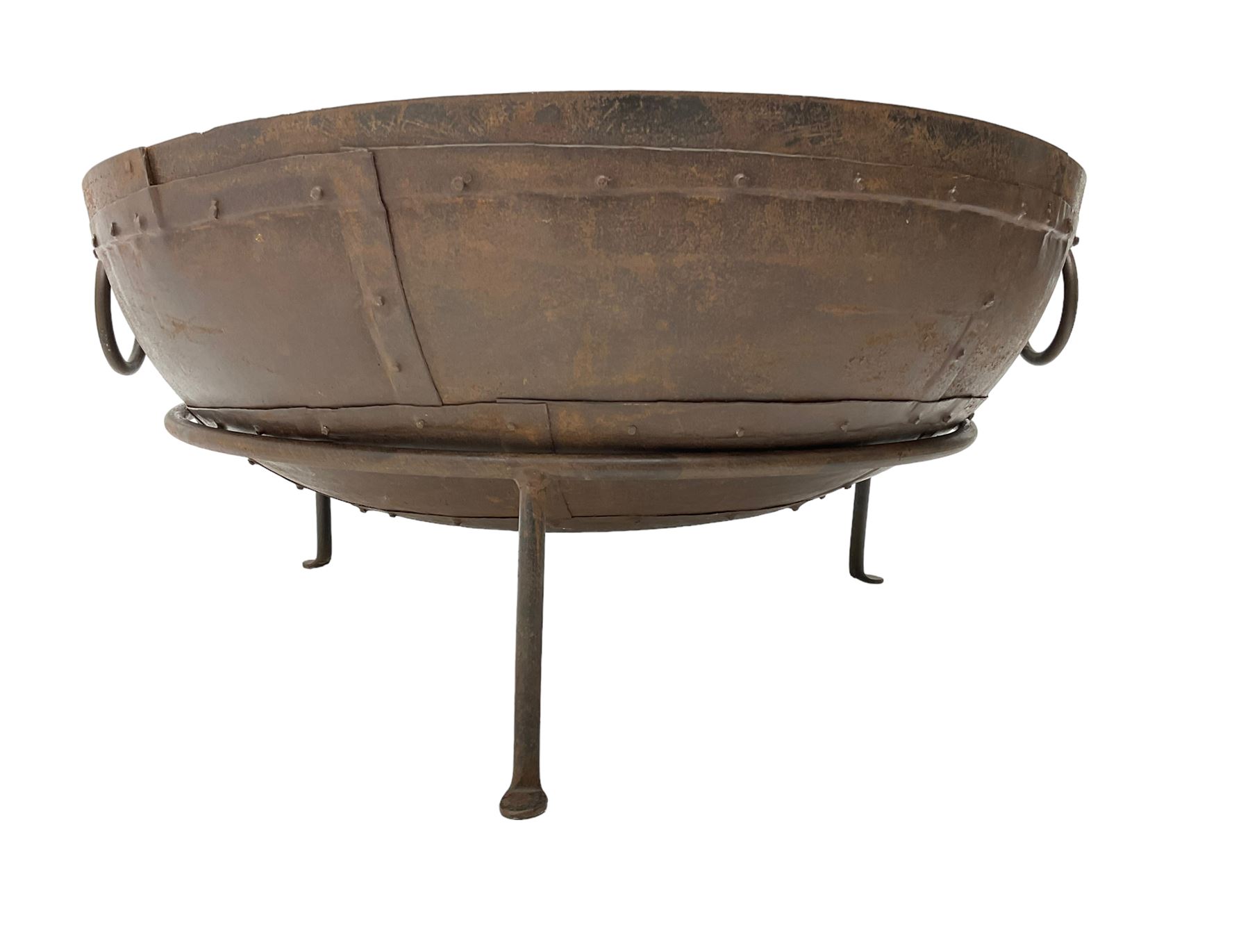 Circular riveted iron fire pit, strapwork sides with twin handles on stand, with grate