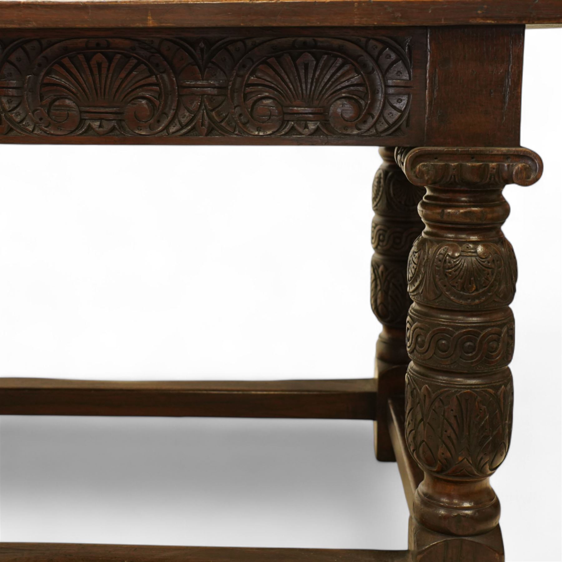 17th century revival oak refectory table, rectangular plank top above a scallop shell carved frieze and baluster turned legs carved with scallop shell and Gothic tracery, joined by stretchers