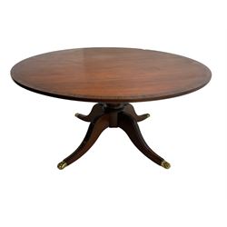 Shaw and Riley of Thirsk - Regency design mahogany dining table, the banded circular top on turned pedestal, four splayed supports with hairy paw brass caps