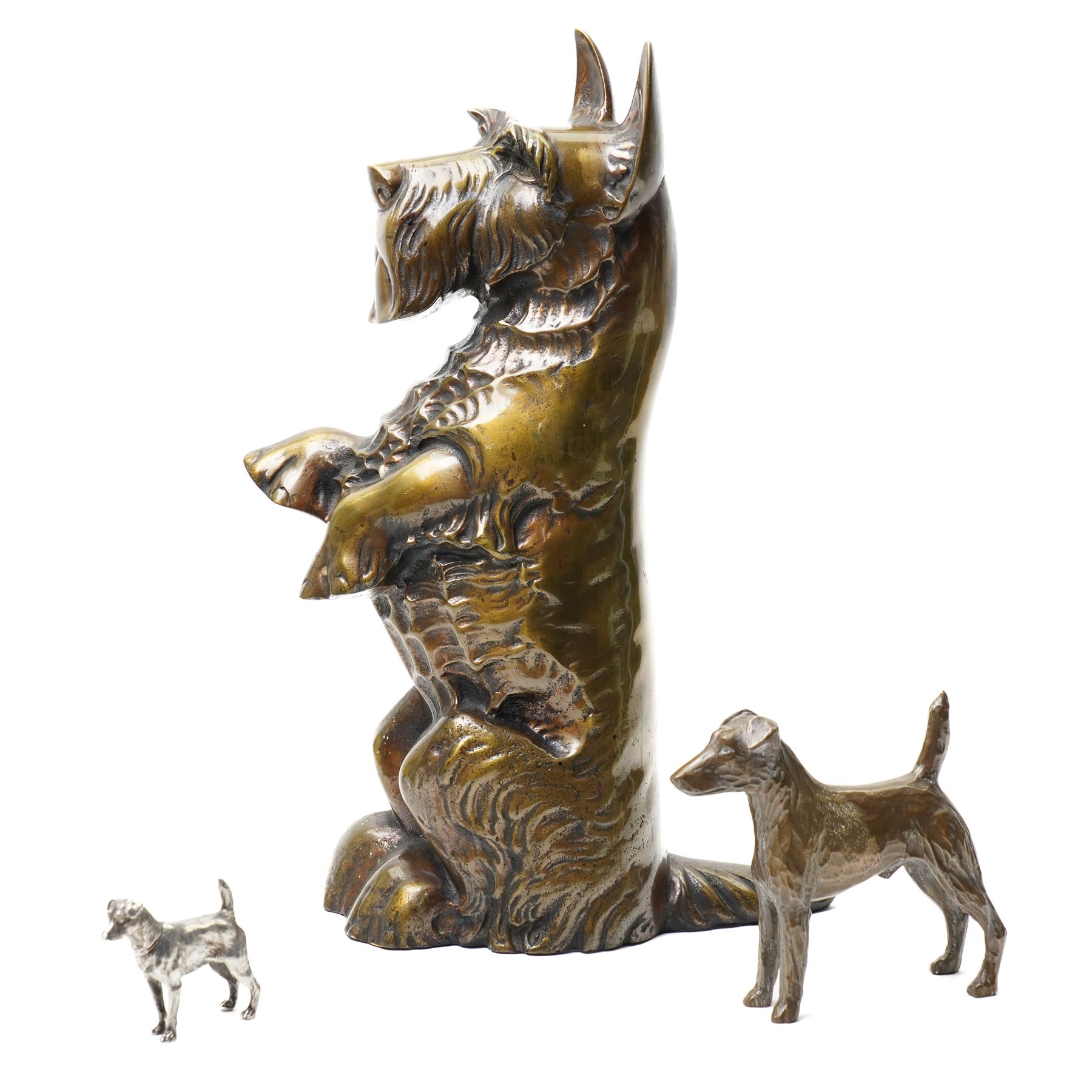 Brass Scottish Terrier fireside companion with accessories, H41cm; with patinated brass Smooth Fox Terrier, H13cm and small silver plated Smooth Fox Terrier, H6cm (3)