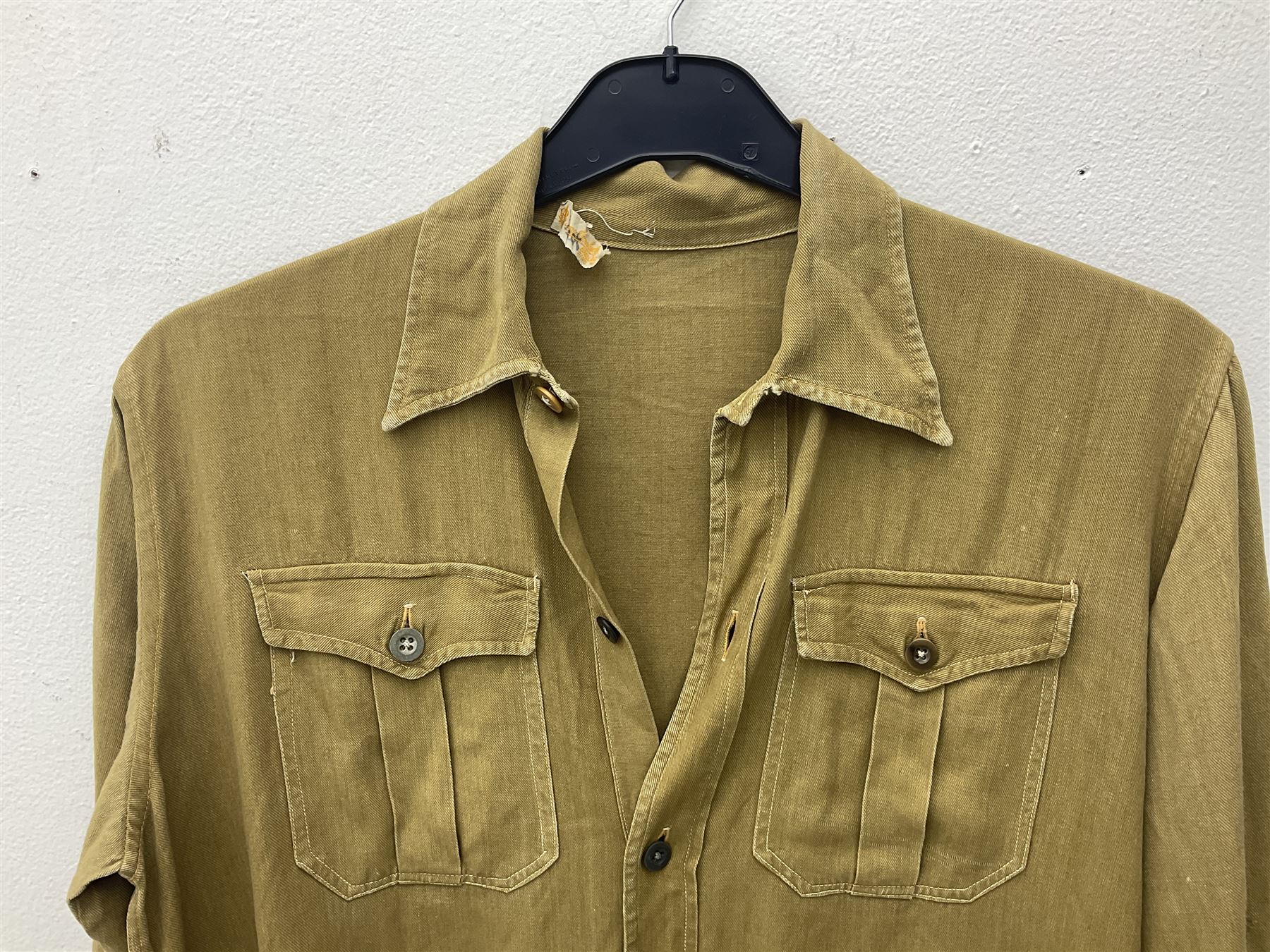 1930s Hitler Youth brown shirt, long length with two pockets, bears triangular badge 'Nord Nordsee'