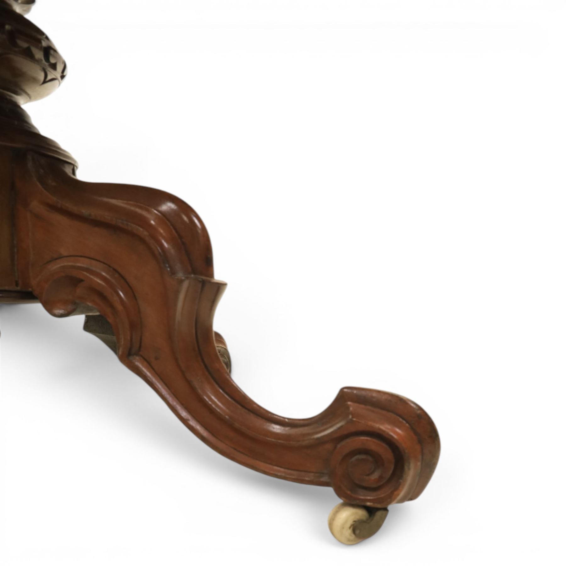 Victorian mahogany oval centre table, raised on turned column with four carved legs, ceramic castors