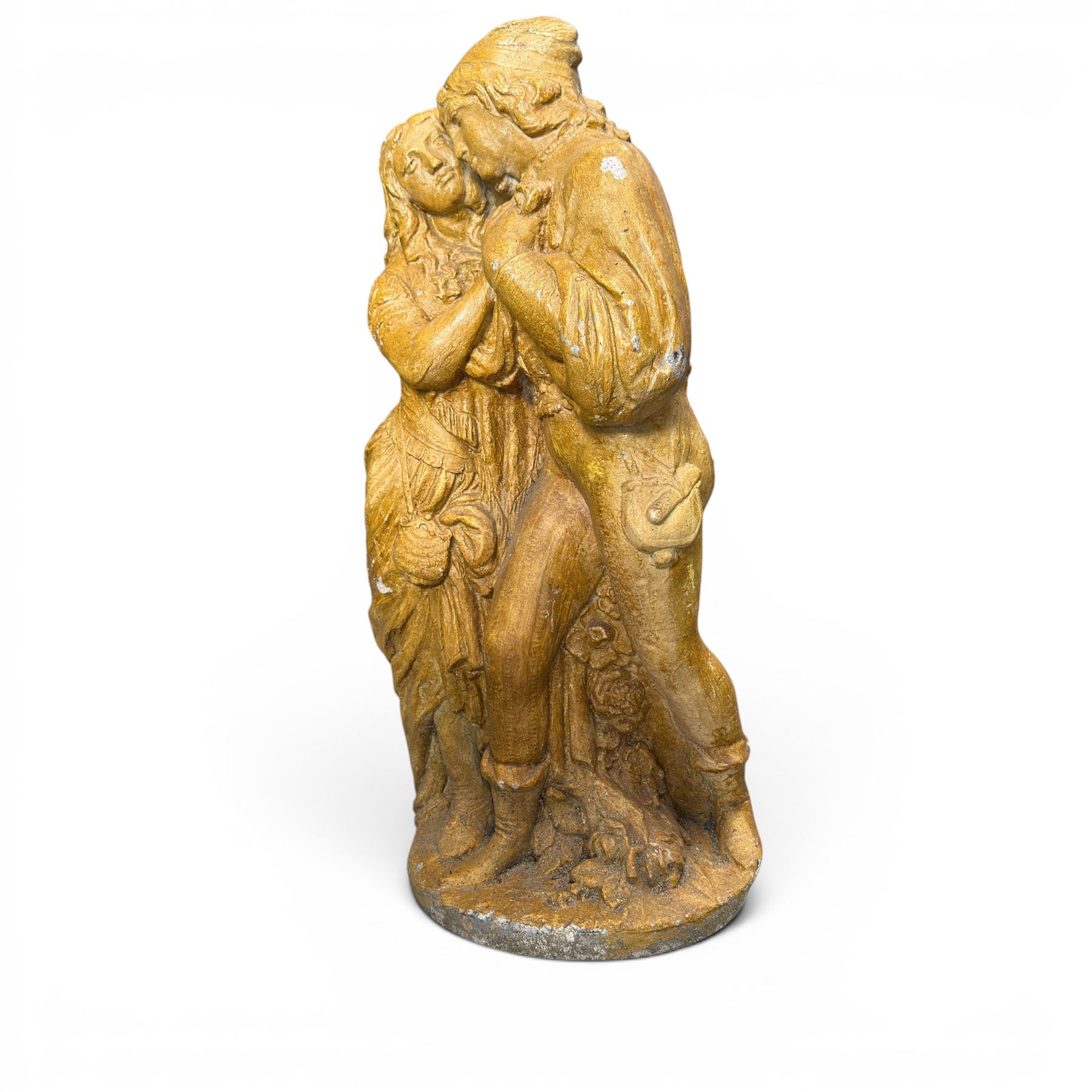 Composite garden statue group of Romeo and Juliet embracing in Medieval dress, surmounted on a naturalistic foliate base, in antique distressed glazed finish