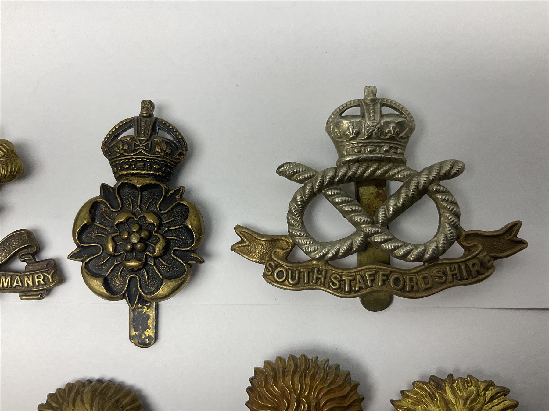 Nineteen Yeomanry metal cap badges including Derbyshire, Northamptonshire, Essex, Glamorgan, Staffordshire, City of London, Surrey, Shropshire, Hertfordshire etc; together with eleven Fusiliers badges including Lancashire, Royal Welch, Northumberland etc (30)