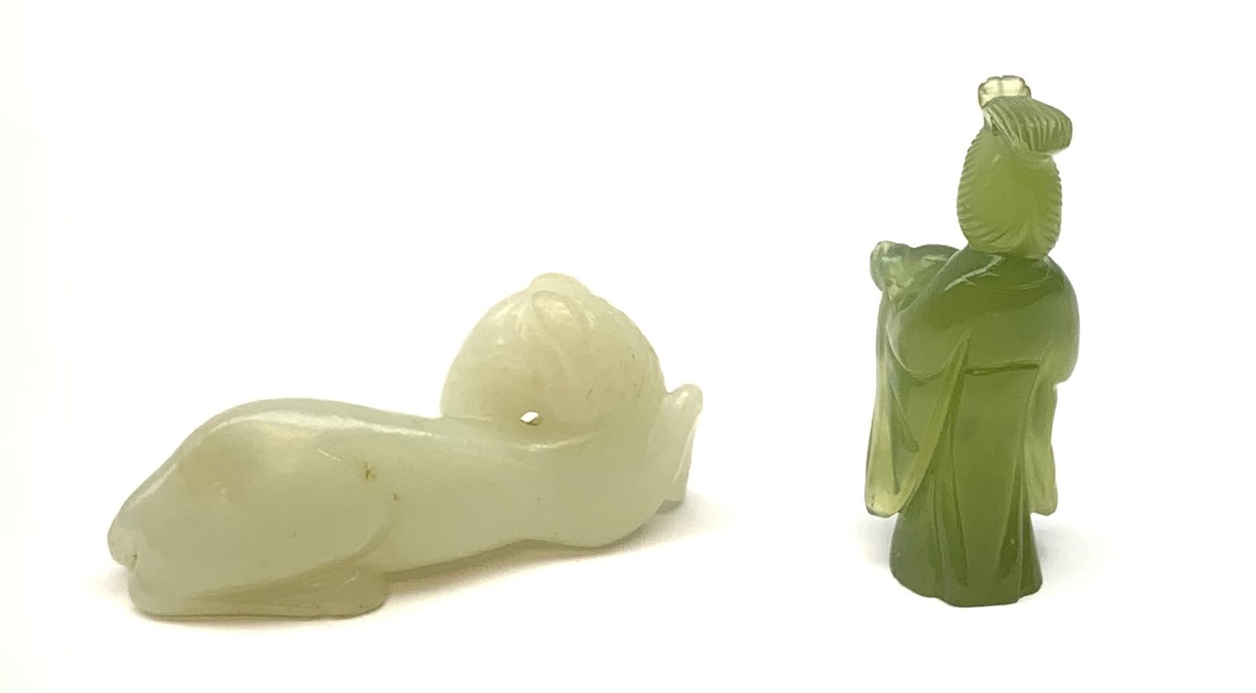 A Chinese celadon jade carved figure, modelled as a recumbent horse, L6cm, together with a nephite jade carved figure modelled as Guanyin, H5.5cm. 