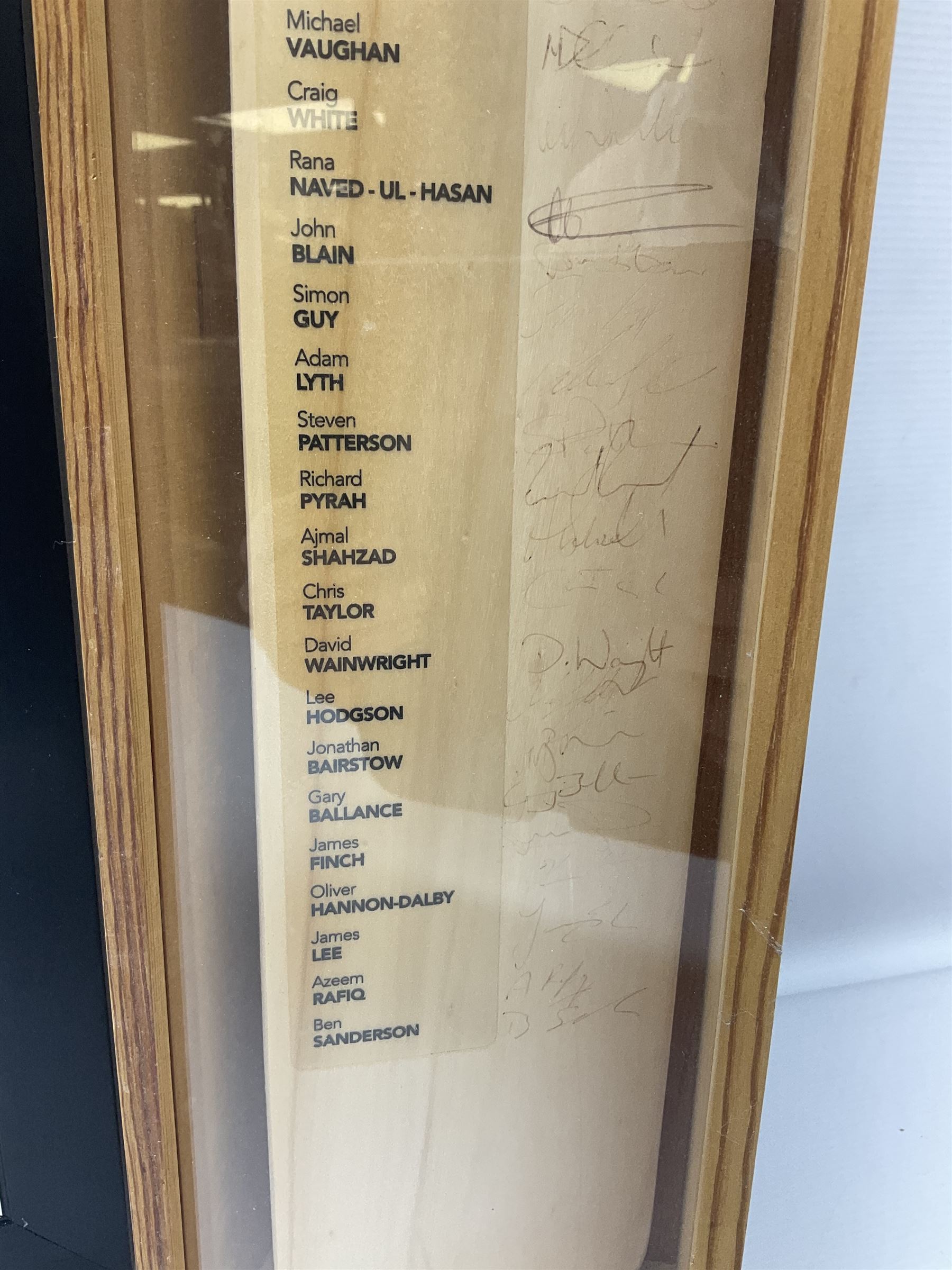 Two signed Yorkshire County cricket bats, bearing signatures including Anthony McGrath, Jacques Rudolph, Michael Vaughn and Matthew Hoggard, etc, both within glazed presentation boxes, box H86.5cm, together with a framed Darren Gough signed presentation print by Gary Keane