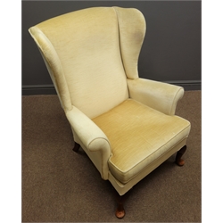  Parker Knoll beech framed wingback armchair, upholstered in beige fabric  