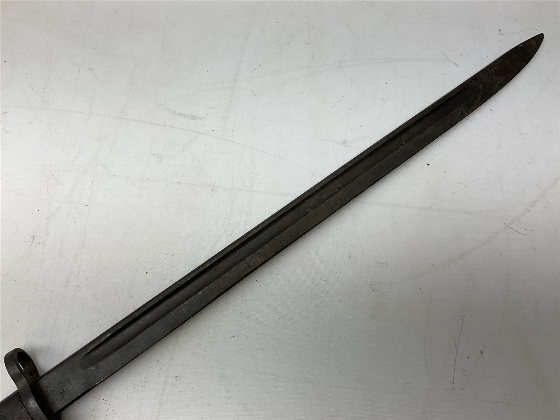 British Pattern 1907 bayonet with 43.5cm fullered steel blade; in leather scabbard with webbing frog L58cm overall; another Pattern 1907 bayonet lacking scabbard; and British Pattern 1888 Mk.I bayonet by Wilkinson London (no scabbard) (3)