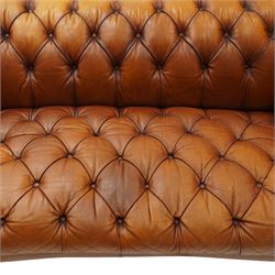 Tetrad - 'Oskar' grande three-seat sofa, Chesterfield shape with rolled arms over serpentine back and front, upholstered in fully buttoned tan leather, raised on reed-moulded feet of globular form