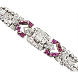 Art Deco platinum diamond and ruby bracelet, circa 1920-1930, the central panel set with a single emerald cut diamond of approx 0.55 carat, flanked by two baguette cut diamonds and old cut diamond surround, the articulated geometric design bracelet with vari-cut rubies, round and baguette cut diamonds, total diamond weight approx 7.00 carat, in Mappin & Webb silk and velvet lined box