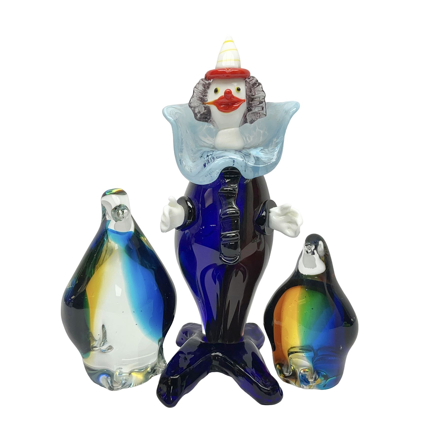 Murano glass clown, together with two glass penguin paperweights, clown H28cm