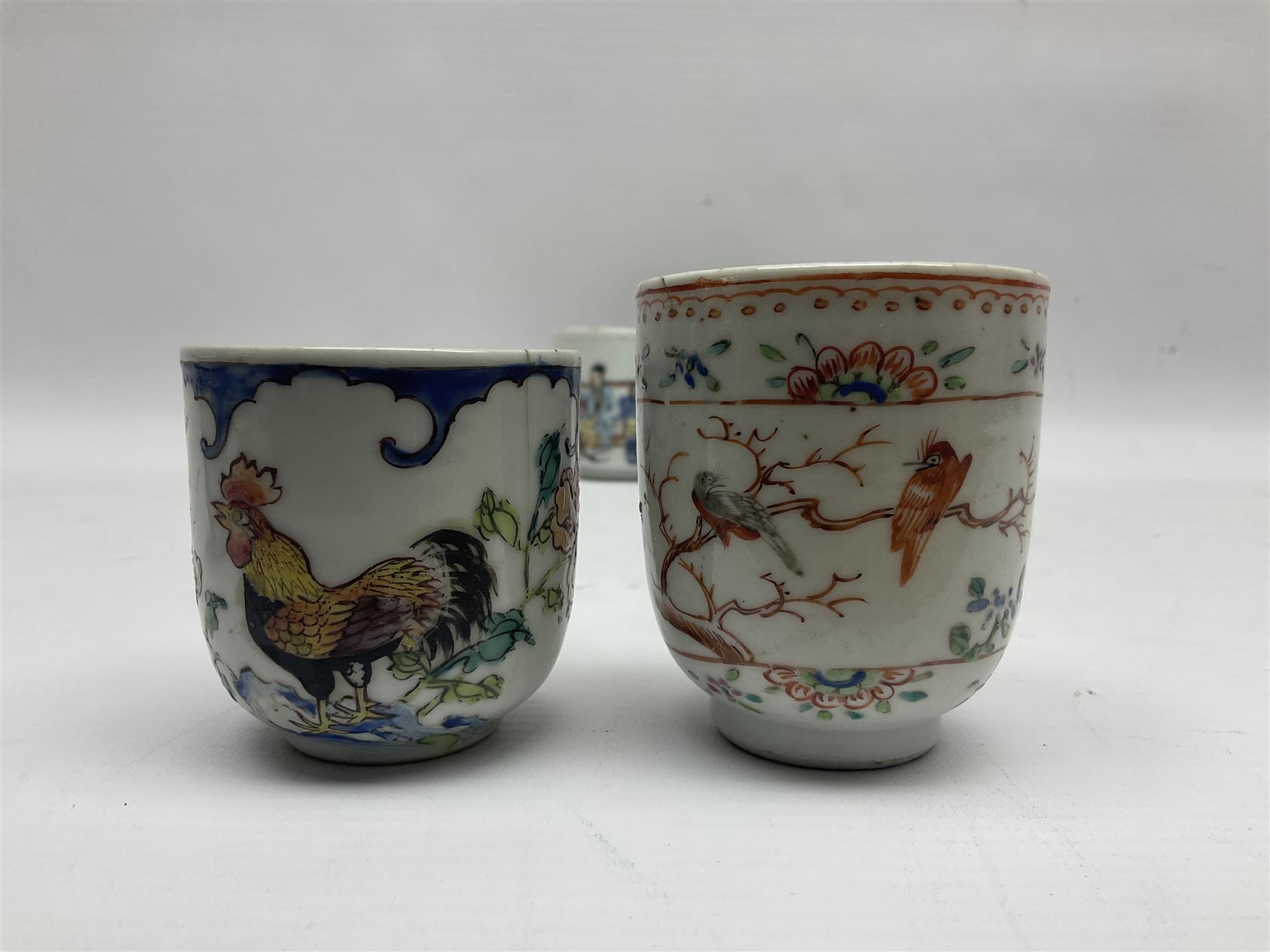 Two 18th century Chinese Yongzheng coffee cups, the first example decorated in polychrome enamel with rooster amidst blossoming peonies, the second decorated with deer and crane among rockwork and pine tree, together with two further 18th century Chinese coffee cups, an 18th century Chinese tea bowl, and a further tea bowl