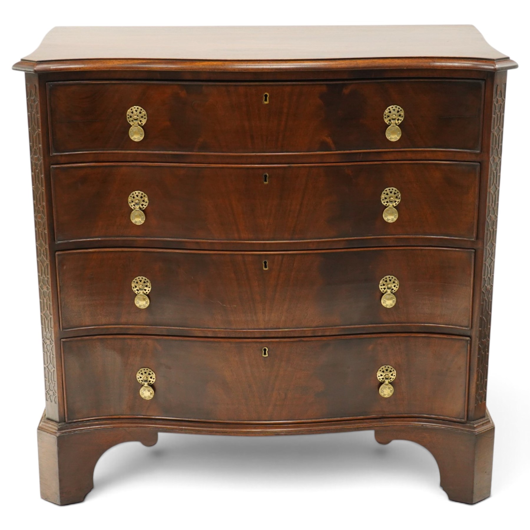 Quality Georgian design mahogany serpentine secretaire chest, the shaped top with moulded edge, fitted with cock-beaded secretaire drawer with button-release fall-front enclosing fitted interior, over three graduating drawers with brass drop handles on pierced circular plates, the canted uprights carved with blind-fret strapwork, lower moulded edge on shaped bracket feet