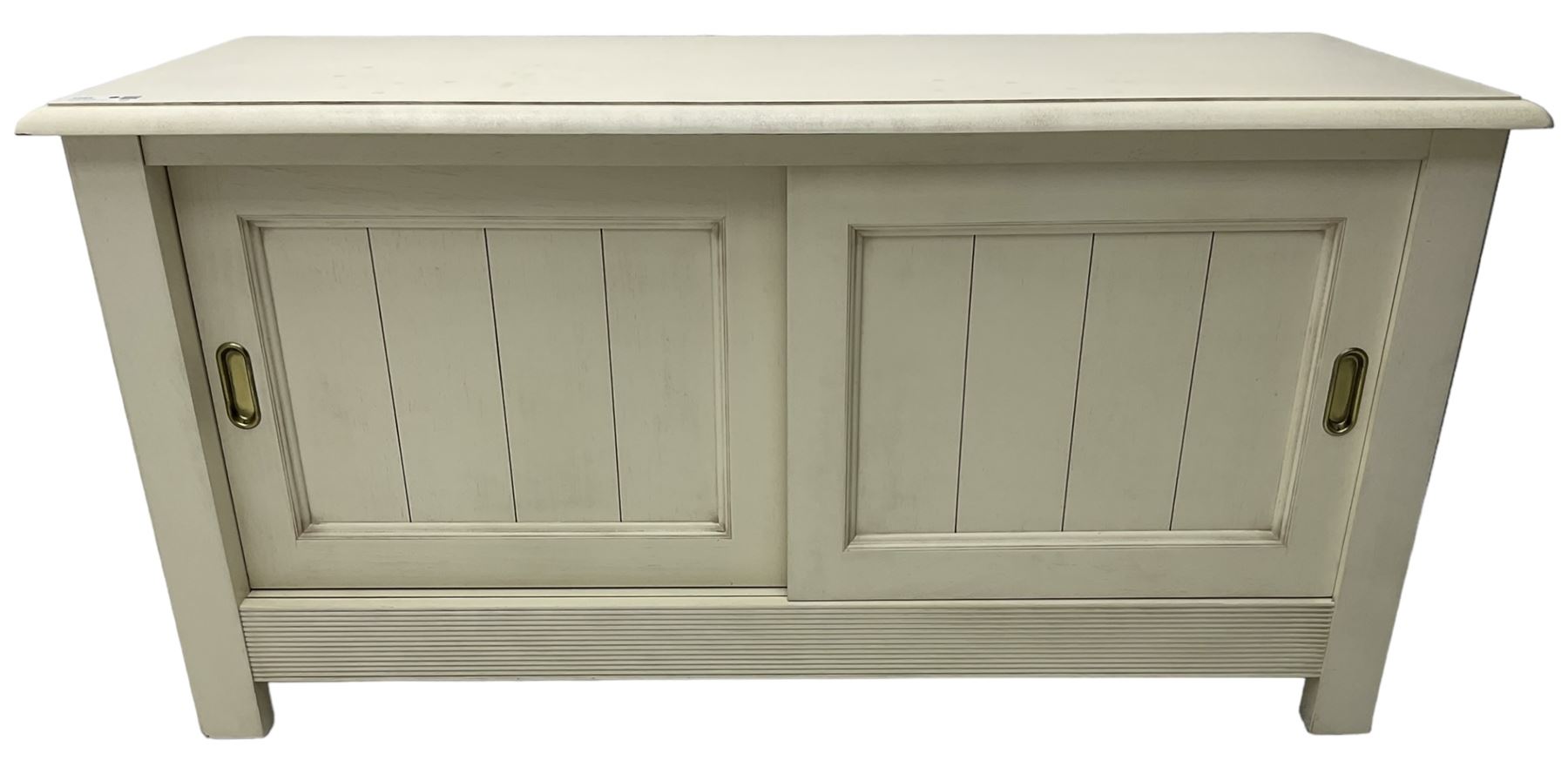 Cream finish low side cabinet, moulded rectangular top over two sliding panelled doors, on stile supports 
