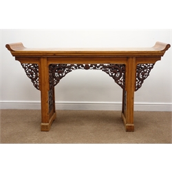  Chinese hardwood altar table, the long oblong top with upward curving ends on two supports with carved panels to either side depicting Ho Ho bird amongst blossom and a dragon over a bridge and fish, with similarly carved corner brackets, W170cm, H96cm, D48cm  